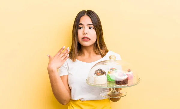 pretty hispanic girl feeling stressed, anxious, tired and frustrated. home made cakes concept