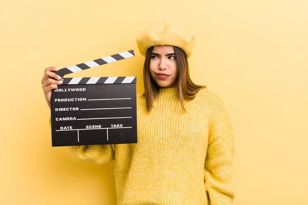 pretty hispanic girl feeling sad, upset or angry and looking to the side cinema concept