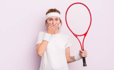 Kızıl saçlı güzel kız elleri ile ağzını kapatıyor. tenis konsepti