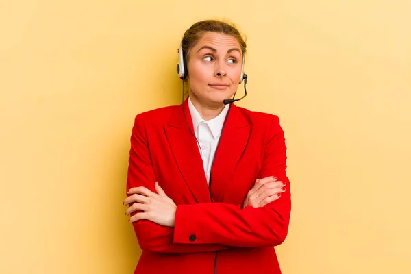 young pretty woman shrugging, feeling confused and uncertain. telemarketer concept