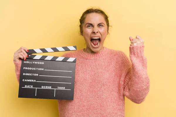 Young Pretty Woman Shouting Aggressively Angry Expression Cinema Clapper Concept — Stock Photo, Image