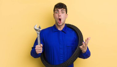 Genç yakışıklı adam, inanılmaz bir sürprizle şaşkına dönmüş ve hayrete düşmüştü. motor tamircisi kavramı