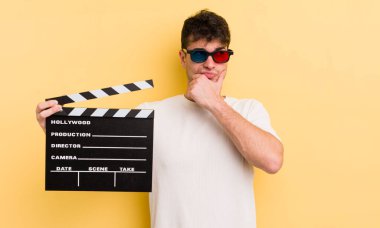 Genç yakışıklı düşünen, kuşkulu ve kafası karışık bir adam. Sinema alkışlama konsepti