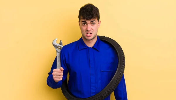 Joven Hombre Guapo Sintiéndose Desconcertado Confundido Concepto Reparador Bicicletas — Foto de Stock