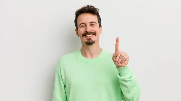 Young Handsome Man Smiling Looking Friendly Showing Number One — Stock Photo, Image