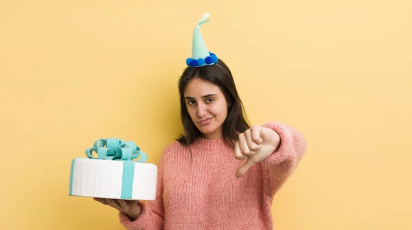 Young Hispanic Woman Feeling Cross Showing Thumbs Birthday Concept — Stock Photo, Image