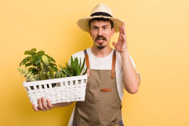 Adam ellerini havaya kaldırarak bağırıyor. Bahçıvan konsepti