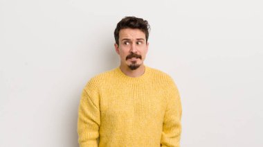 İspanyol genç adam endişeli, stresli, endişeli ve korkmuş görünüyor, panikliyor ve dişlerini sıkıyor