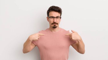 İspanyol genç adam gururlu, pozitif ve iki eliyle göğsünü gösteren