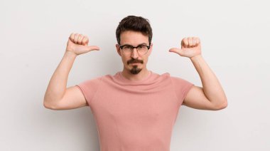 İspanyol genç adam gururlu, kibirli ve kendinden emin, tatmin olmuş ve başarılı görünüyor, kendini işaret ediyor.