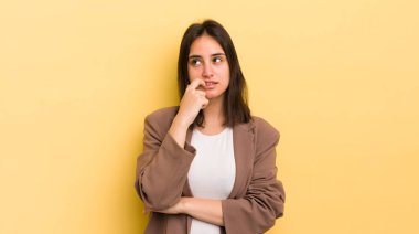 Şaşırmış, gergin, endişeli ya da korkmuş bakışları olan genç İspanyol kadın fotokopi alanına doğru yan bakıyor.