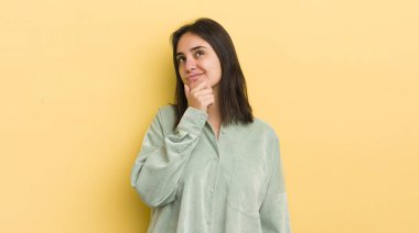 Genç İspanyol kadın düşünüyor, kuşkulu ve şaşkın hissediyor, farklı seçeneklerle, hangi kararı vereceğini merak ediyor.