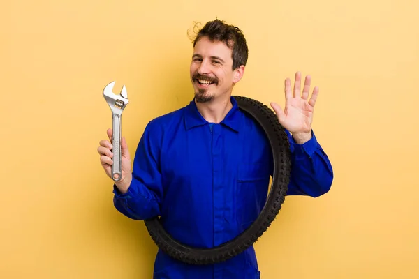 Man Smiling Happily Waving Hand Welcoming Greeting You Bike Repairman — Stock Photo, Image
