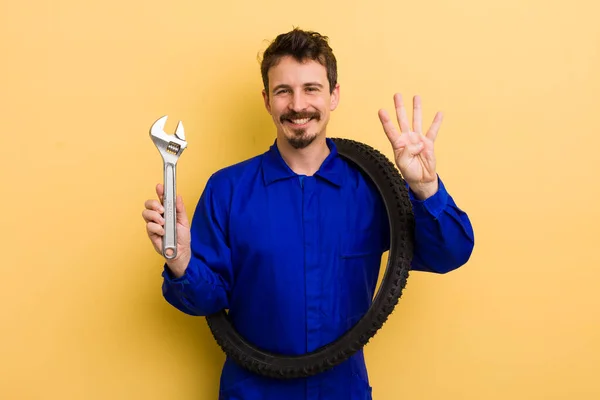 Man Smiling Looking Friendly Showing Number Four Bike Repairman Concept — Stock Photo, Image
