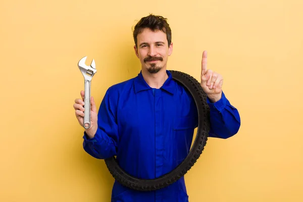 Mann Lächelt Und Sieht Freundlich Aus Zeigt Nummer Eins Fahrradwerkstatt — Stockfoto