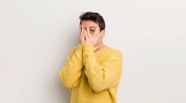Hispanic Young Man Covering Face Hands Peeking Fingers Surprised Expression — Stock Photo, Image