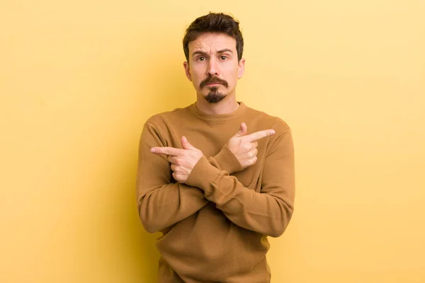 Young Hispanic Man Looking Puzzled Confused Insecure Pointing Directions Doubts — Stock Photo, Image