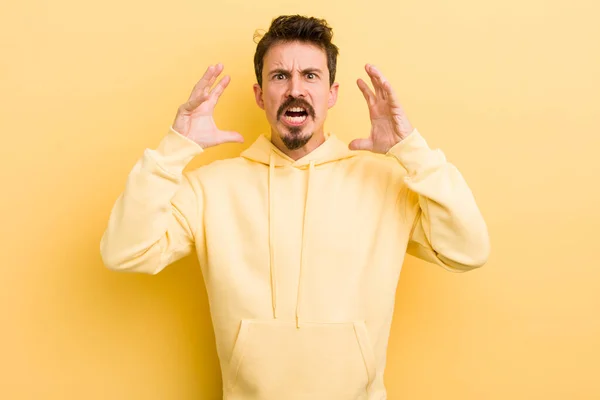 Young Hispanic Man Screaming Hands Air Feeling Furious Frustrated Stressed — Stockfoto
