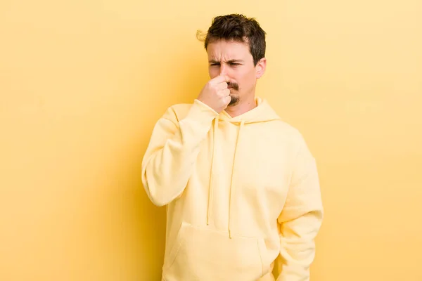 Young Hispanic Man Feeling Disgusted Holding Nose Avoid Smelling Foul — Stock Photo, Image
