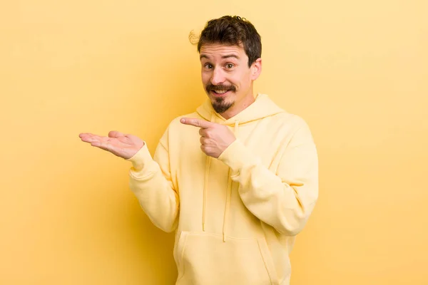 Young Hispanic Man Smiling Cheerfully Pointing Copy Space Palm Side — Stock Photo, Image