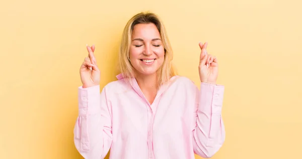 Blonde Caucasian Woman Smiling Anxiously Crossing Both Fingers Feeling Worried — Stockfoto
