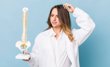 Güzel kadın şaşkın ve kafası karışmış hissediyor, başını kaşıyor.