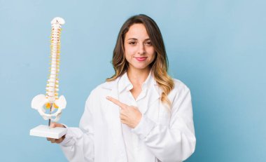 Güzel bir kadın neşeyle gülümsüyor, mutlu hissediyor ve bir tarafı işaret ediyor.