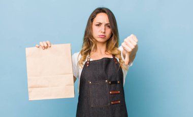 Güzel bir kadın kendini kötü hissediyor, baş parmağını kaldırıyor.