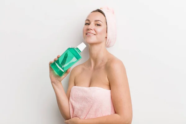 pretty blonde woman with a mouth wash bottle