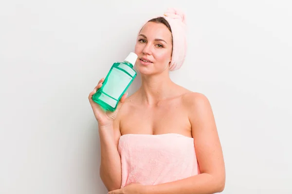 pretty blonde woman with a mouth wash bottle