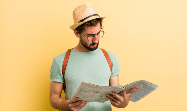 young bearded tourist man with a map