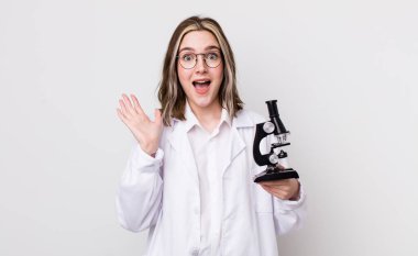 Kafkasyalı bir kadın kendini mutlu hissediyor ve inanılmaz bir şeye hayret ediyor. Mikroskop konseptine sahip bilim adamı