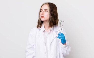 Profil görünümlü beyaz bir kadın hayal kuruyor, hayal kuruyor ya da hayal kuruyor. dişçi kavramı