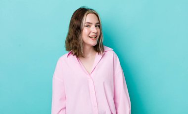 pretty caucasian woman with a big, friendly, carefree smile, looking positive, relaxed and happy, chilling