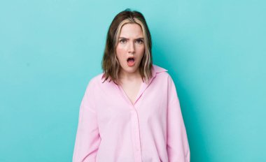 pretty caucasian woman looking shocked, angry, annoyed or disappointed, open mouthed and furious