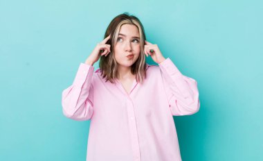 pretty caucasian woman looking concentrated and thinking hard on an idea, imagining a solution to a challenge or problem