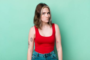 pretty caucasian woman feeling confused and doubtful, wondering or trying to choose or make a decision