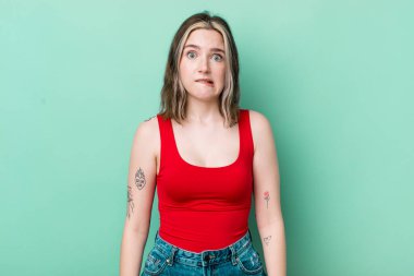 pretty caucasian woman feeling clueless, confused and uncertain about which option to pick, trying to solve the problem