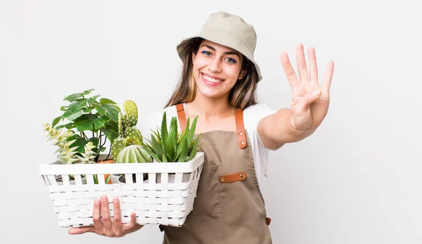 Pretty Hispanic Woman Smiling Looking Friendly Showing Number Four Plants — Stock Photo, Image