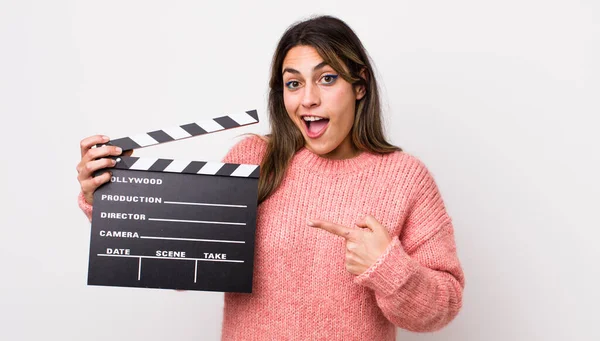 Pretty Hispanic Woman Looking Excited Surprised Pointing Side Cinema Clapper — Stock Photo, Image