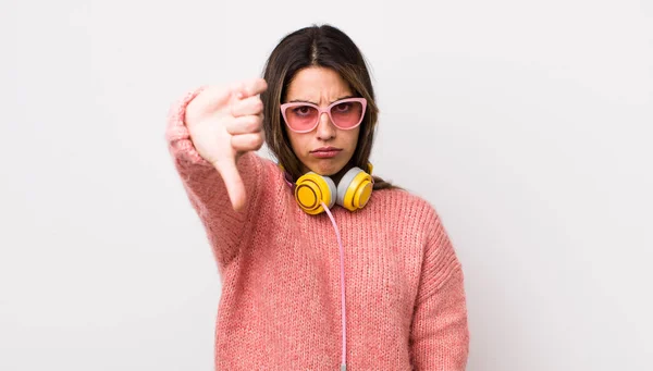 Pretty Hispanic Woman Feeling Cross Showing Thumbs Headphones Concept — Stock Photo, Image