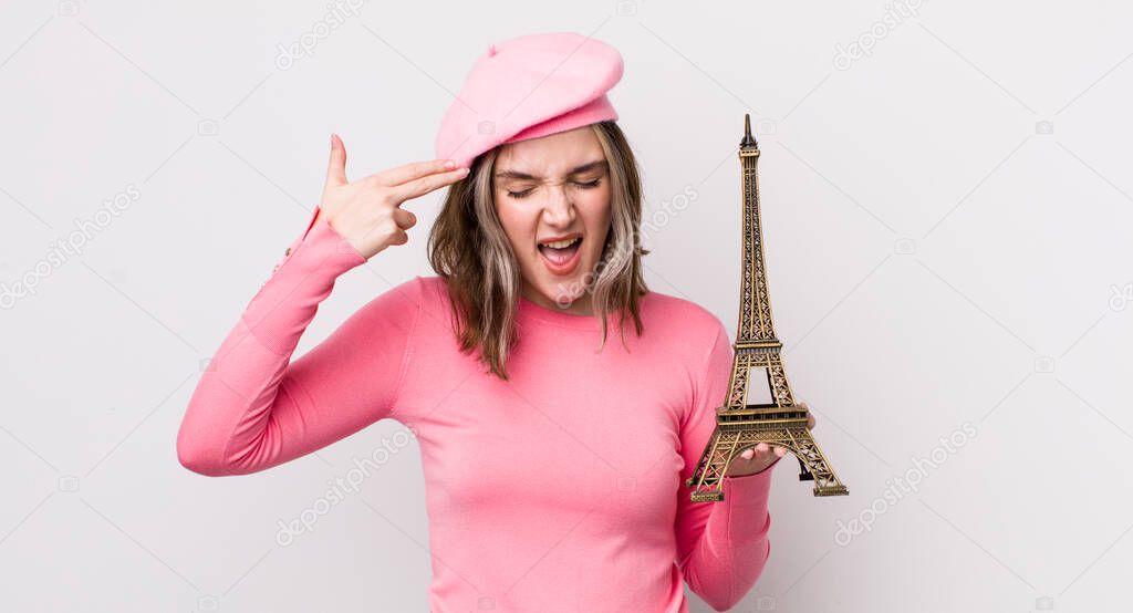 pretty caucasian woman looking unhappy and stressed, suicide gesture making gun sign. france concept