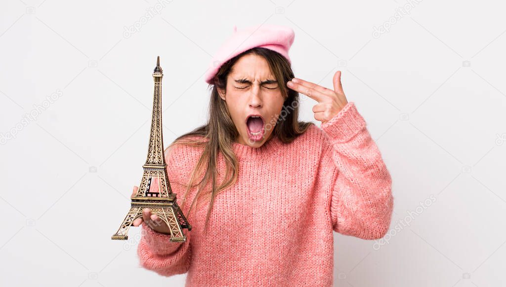 pretty hispanic woman looking unhappy and stressed, suicide gesture making gun sign. france concept