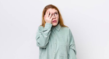 Güzel kızıl saçlı kadın, yorgun, sıkıcı ve sıkıcı bir işten sonra sıkılmış, hayal kırıklığına uğramış ve uykulu hissediyor.