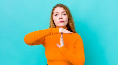 Güzel kızıl saçlı kadın ciddi, sert, kızgın ve canı sıkkın görünüyor.