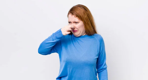 Pretty Red Head Woman Feeling Disgusted Holding Nose Avoid Smelling — Stock Photo, Image