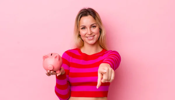 Blonde Pretty Woman Pointing Camera Choosing You Piggy Bank Concept — Stockfoto