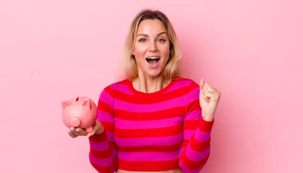 Blonde Pretty Woman Feeling Shocked Laughing Celebrating Success Piggy Bank — Stockfoto