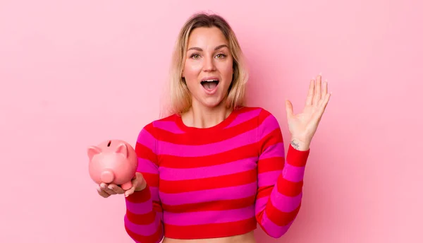 Blonde Pretty Woman Feeling Happy Astonished Something Unbelievable Piggy Bank — Stockfoto