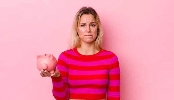Blonde Pretty Woman Looking Puzzled Confused Piggy Bank Concept — Stockfoto